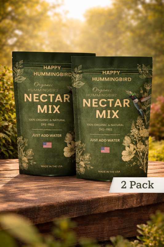 Two packages of Happy Hummingbird Nectar Mix on a wooden surface with a natural background.